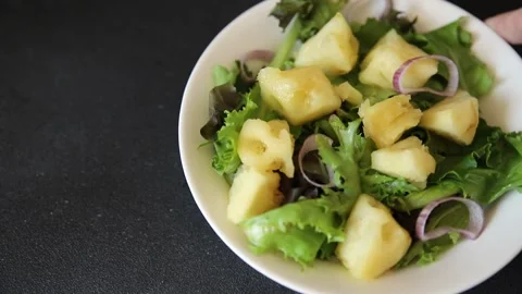 Pineapple Salad mixed green salad leaves and pineapple chunks food preparation Stock Footage 341160065