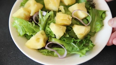 Pineapple Salad mixed green salad leaves and pineapple chunks food preparation Stock Footage 341160069