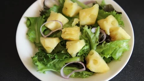 Pineapple Salad mixed green salad leaves and pineapple chunks food preparation Stock Footage 341160077