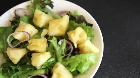 Pineapple Salad mixed green salad leaves and pineapple chunks food preparation Stock Footage 341160082