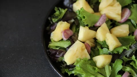 Pineapple Salad mixed green salad leaves and pineapple chunks food preparation Stock Footage 341160083