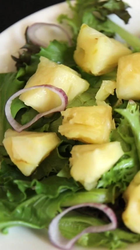 Pineapple Salad mixed green salad leaves and pineapple chunks food preparation Stock Footage 341160091