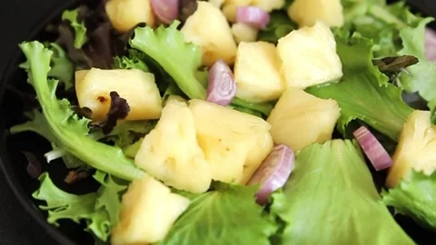 Pineapple Salad mixed green salad leaves and pineapple chunks food preparation Stock Footage 341160098