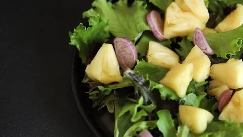 Pineapple Salad mixed green salad leaves and pineapple chunks food preparation Stock Footage 341160099