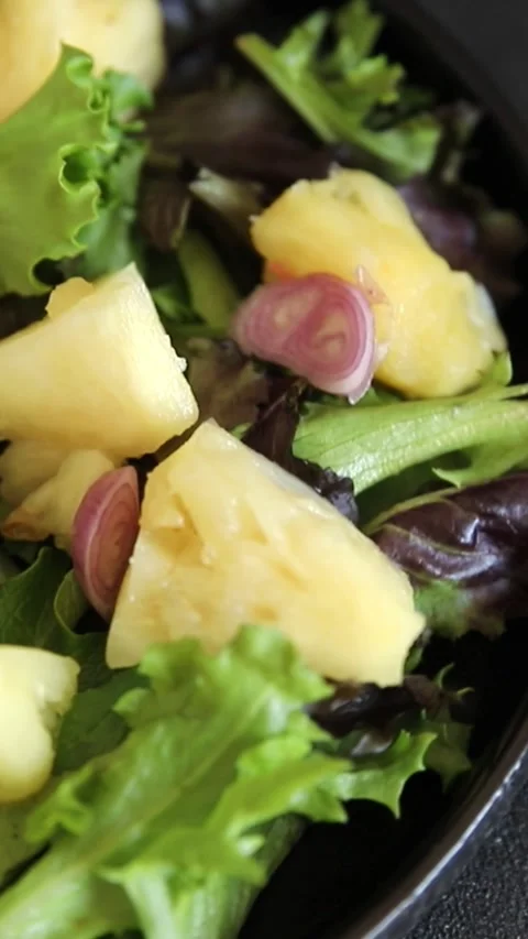 Pineapple Salad mixed green salad leaves and pineapple chunks food preparation Stock Footage 341160100