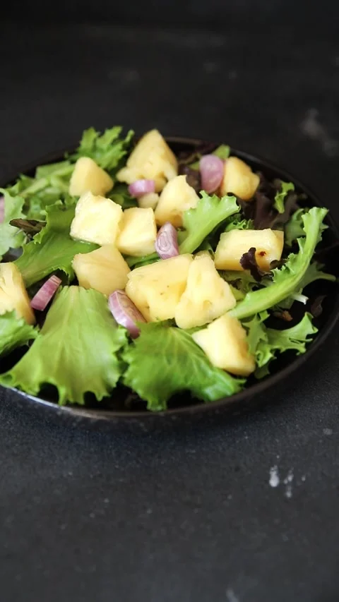 Pineapple salad mixed green salad leaves and pineapple chunks food Stock Footage 343160759