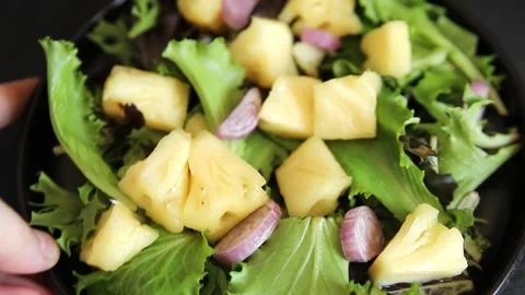 Pineapple salad mixed green salad leaves and pineapple chunks food Stock Footage 343160761