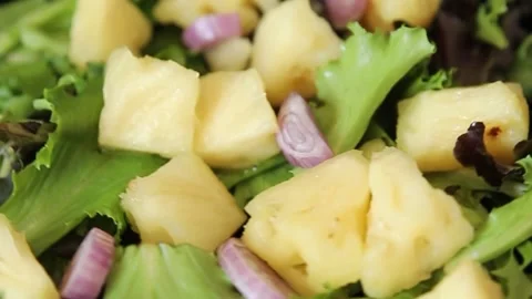 Pineapple salad mixed green salad leaves and pineapple chunks food Stock Footage 343160762