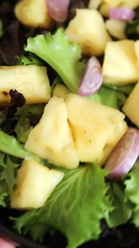 Pineapple salad mixed green salad leaves and pineapple chunks food Stock Footage 343160764