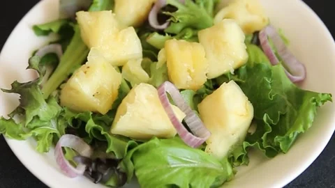 Pineapple salad mixed green salad leaves and pineapple chunks food Stock Footage 343160765