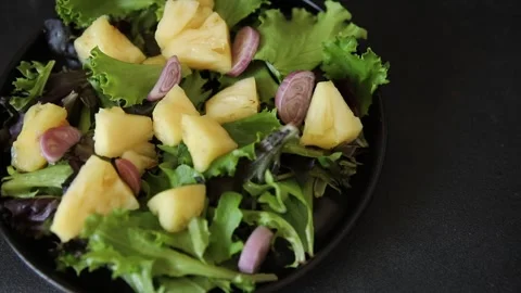 Pineapple salad mixed green salad leaves and pineapple chunks food Stock Footage 343160767