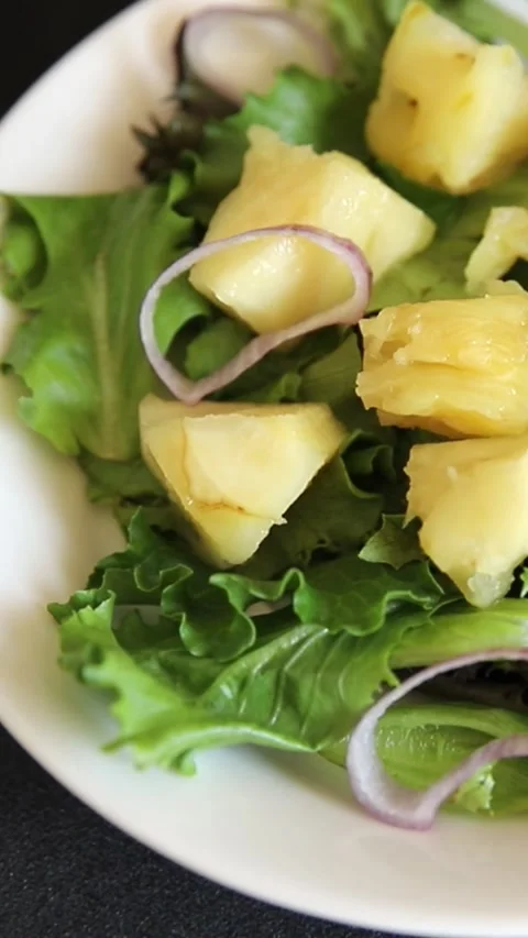 Pineapple salad mixed green salad leaves and pineapple chunks food Stock Footage 343160768