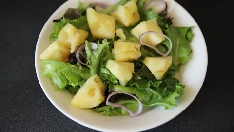 Pineapple salad mixed green salad leaves and pineapple chunks food Stock Footage 343160769