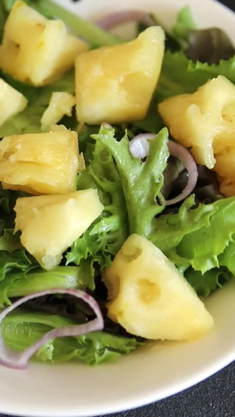 Pineapple salad mixed green salad leaves and pineapple chunks food Stock Footage 343160770