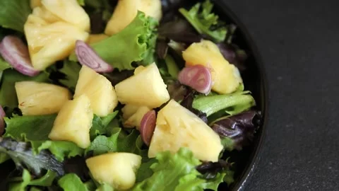 Pineapple salad mixed green salad leaves and pineapple chunks food Stock Footage 343160776