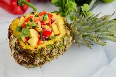 Pineapple salsa in pineapple bowl Stock Photos