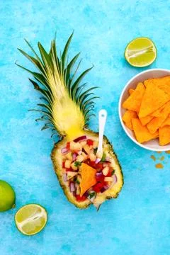 Pineapple salsa served in a pineapple shell Stock Photos