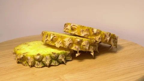 The pineapple sections rotate on the turntable Stock Footage 76544792