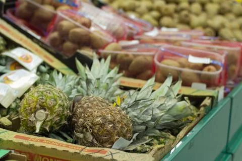 Pineapple on shelf in store Stock Photos