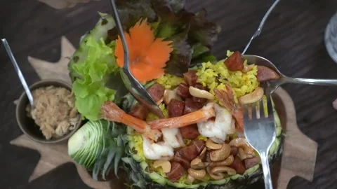 Pineapple shrimp fried rice fruit bowl Thailand Thai food tropical exotic men Stock Footage 283054228