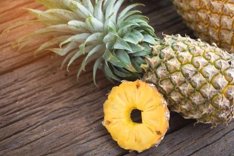 Pineapple slice with copy space on the wood texture background Stock Photos