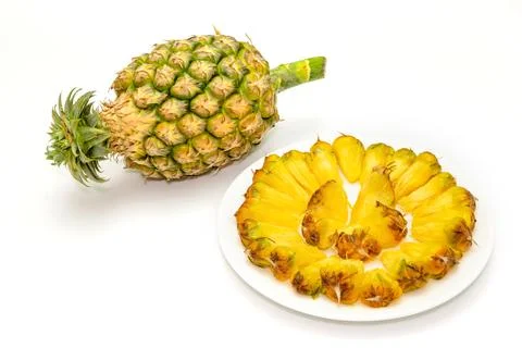 Pineapple slice on a plate isolated on white background Stock Photos