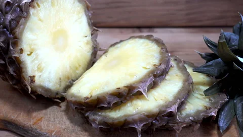 Pineapple sliced on a wooden table. Stock Footage 86546712