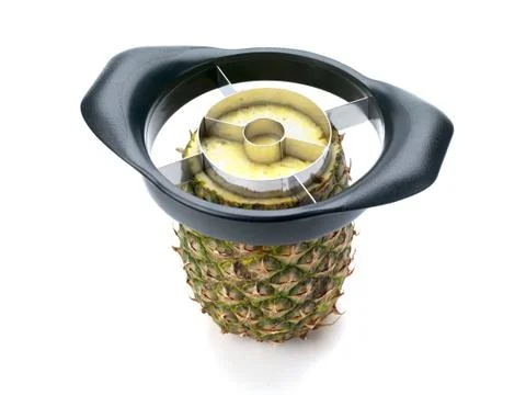 Pineapple with slicer on white Stock Photos