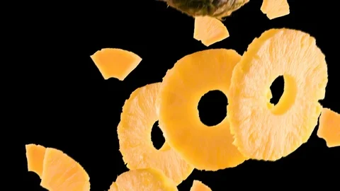 Pineapple with Slices Falling on Black Background Stock Footage 107952729