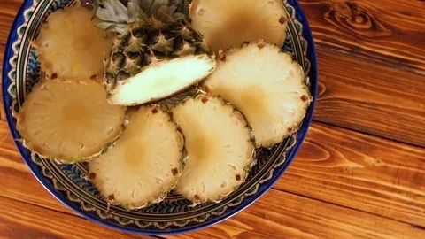 Pineapple with slices rotating on asian dish Stock Footage 71167216