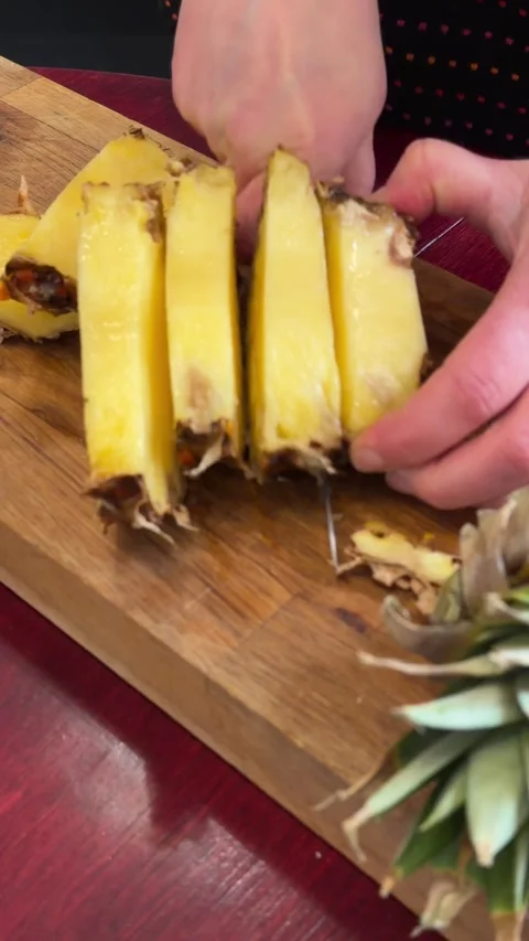 Pineapple slicing process from different angle close up vertical kitchen video 库存影片 331324292
