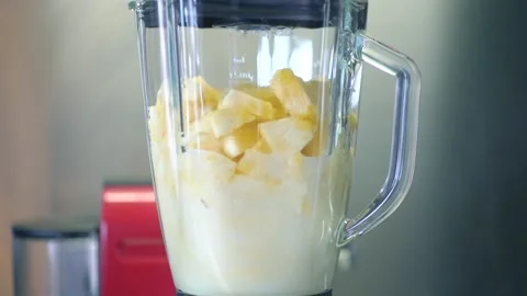 Pineapple smoothie in a blender close-up Stock Footage 134005913