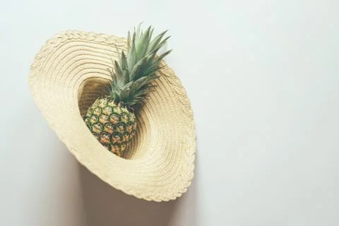 Pineapple in straw hat Stock Photos