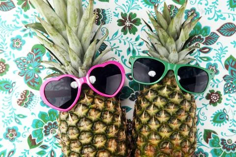 Pineapple with sunglasses on patterned background Stock Photos