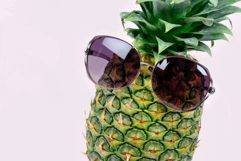 Pineapple with sunglasses on violet background Stock Photos