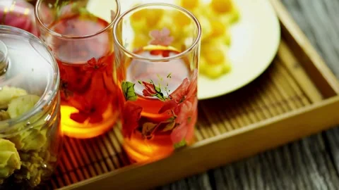 Pineapple tarts and red drinks on festive wooden tray Video stock 333811338