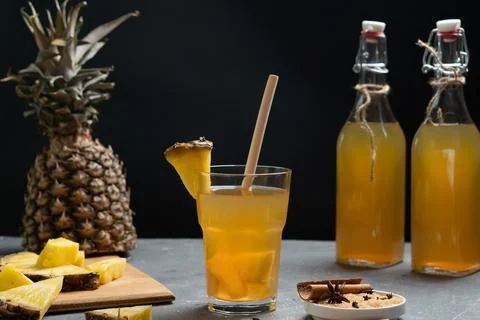 Pineapple Tepache. Fermented drink from pineapple. Low key. Dark background. Stock Photos