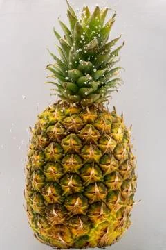 Pineapple under water covered with bubbles and with bubbles in the background Stock Photos