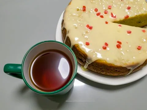 Pineapple Upside Down Cake and cup of tea on white wooden table. Top view. Stock Photos