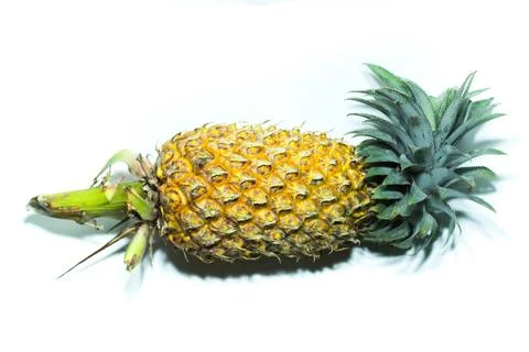 Pineapple on a white background with its sides visible Stock Photos