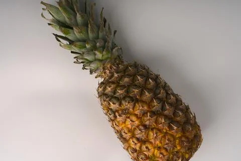 Pineapple on a white flatlay background. Stock Photos