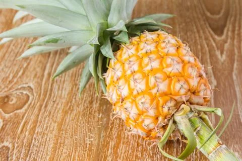 Pineapple on wood table Stock Photos