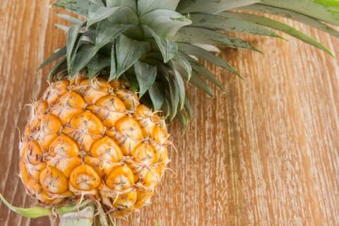 Pineapple on wood table Stock Photos