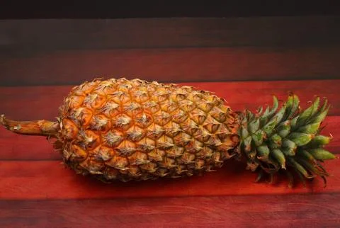 Pineapple on a wood table top Stock Photos