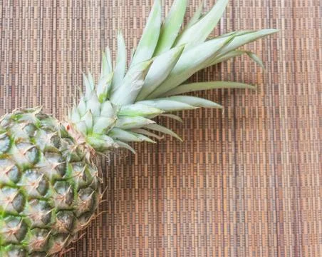 Pineapple on the wooden background surface. Pineapple closeup.. Stock Photos