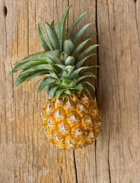 Pineapple on a wooden table. Stock Photos