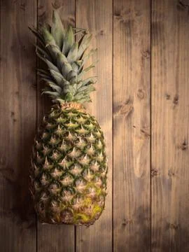 Pineapple on a wooden table Stock Photos