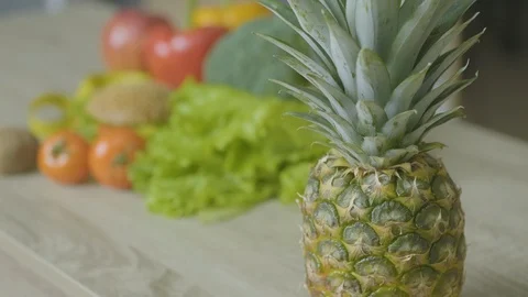 Pineapple on a wooden table. Slow Motion Camera Stock Footage 128654809