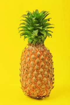 Pineapple on a yellow background Stock Photos