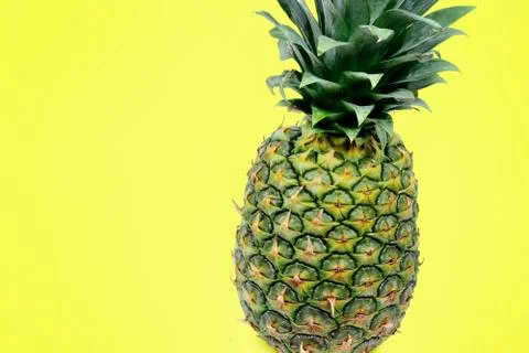 Pineapple on yellow background Stock Photos